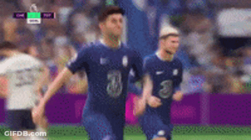 A Group Of Soccer Players Are Playing A Game On A Field . GIF