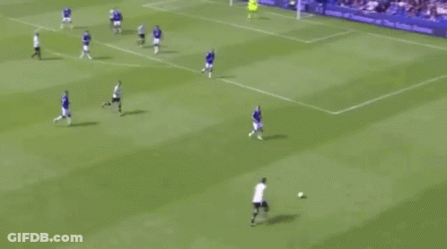 A Group Of Soccer Players Are Playing A Game On A Field With A Crowd Watching . GIF