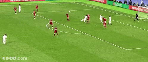 A Group Of Soccer Players Are Playing A Game On A Field With Advertisements On The Sidelines . GIF