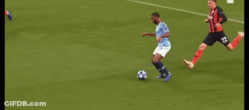 A Group Of Soccer Players Are Playing A Game On A Soccer Field . GIF