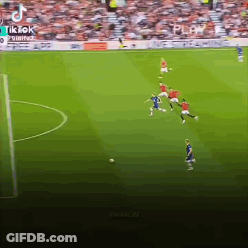A Group Of Soccer Players Are Playing A Game On A Soccer Field . GIF