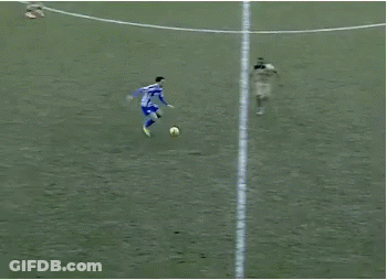 A Group Of Soccer Players Are Playing On A Field And One Of Them Is Wearing A Blue And White Striped Shirt GIF