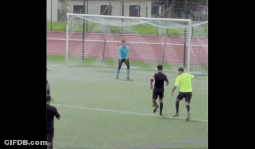 A Group Of Soccer Players Are Playing On A Field And One Of Them Is Wearing A Blue Jersey GIF