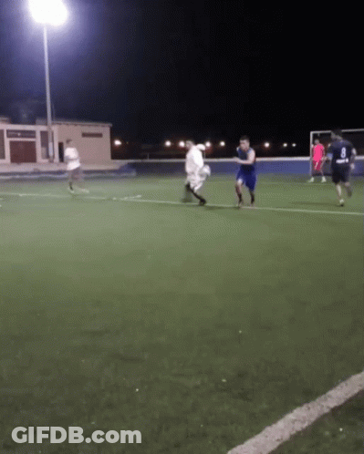 A Group Of Soccer Players Are Playing On A Field At Night And One Of Them Is Wearing A Number 8 Jersey GIF