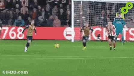 A Group Of Soccer Players Are Playing On A Field . GIF