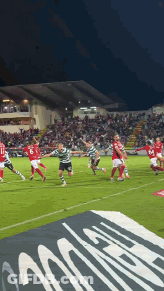 A Group Of Soccer Players Are Playing On A Field With A Banner In The Foreground That Says ' Allianz ' GIF