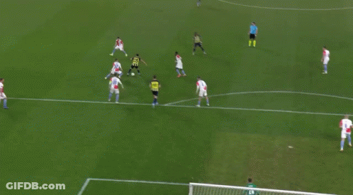 A Group Of Soccer Players Are Playing On A Field With A Goalie GIF