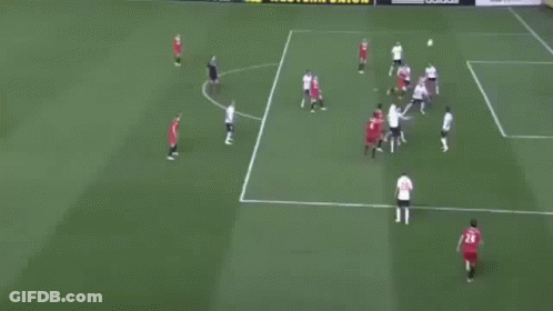 A Group Of Soccer Players Are Playing On A Field With A Goalie In A Blue Uniform GIF