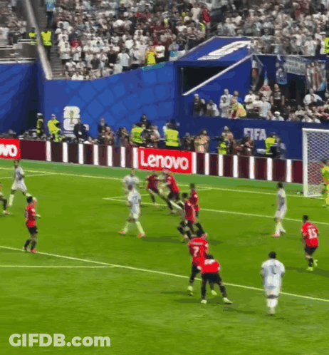 A Group Of Soccer Players Are Playing On A Field With A Lenovo Sign Behind Them GIF
