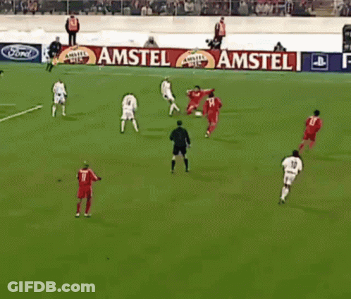 A Group Of Soccer Players Are Playing On A Field With A Playstation 2 Banner Behind Them GIF