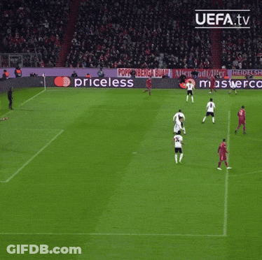 A Group Of Soccer Players Are Playing On A Field With A Ps4 Ad In The Background GIF