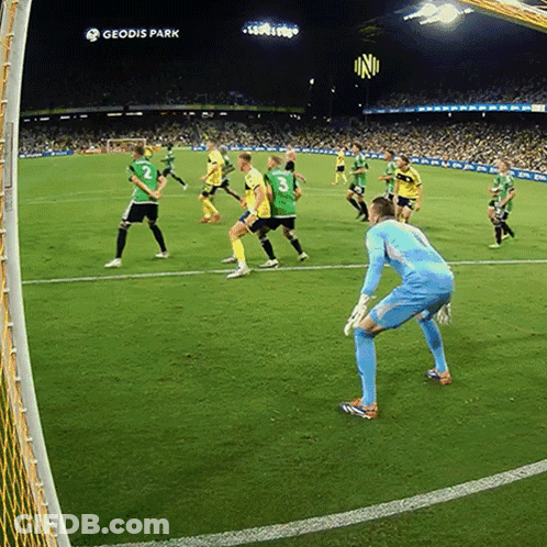 A Group Of Soccer Players Are Playing On A Field With Geodis Park In The Background GIF