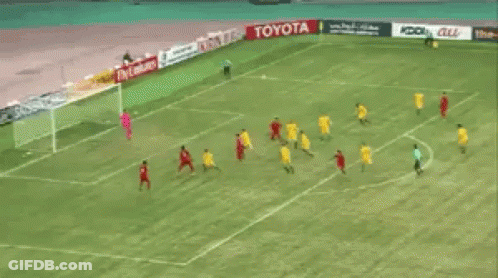A Group Of Soccer Players Are Playing On A Field With Toyota Advertisements Behind Them GIF