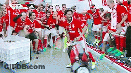 A Group Of Soccer Players Are Posing For A Photo In A Locker Room . GIF