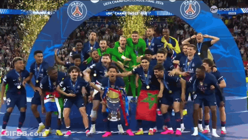 A Group Of Soccer Players Are Posing For A Photo With A Trophy That Says Paris GIF