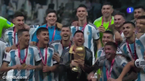 A Group Of Soccer Players Are Posing For A Picture While Holding A Trophy GIF