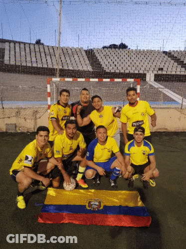 A Group Of Soccer Players Are Posing For A Picture With A Flag In Front Of Them GIF