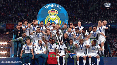 A Group Of Soccer Players Are Posing For A Picture With A Trophy That Says Winners On It GIF