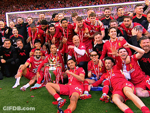 A Group Of Soccer Players Are Posing For A Picture With The Trophy GIF