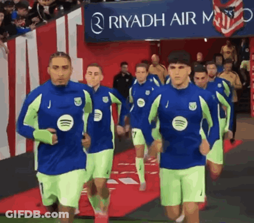 A Group Of Soccer Players Are Running In Front Of A Riyadh Air Logo GIF