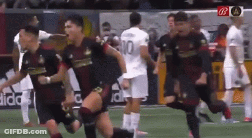 A Group Of Soccer Players Are Running On A Field And One Of Them Has The Number 10 On His Jersey GIF