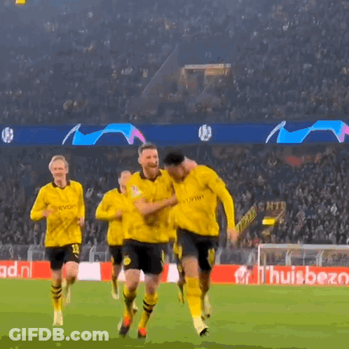 A Group Of Soccer Players Are Running On A Field In Front Of A Banner That Says ' Huisbet ' GIF