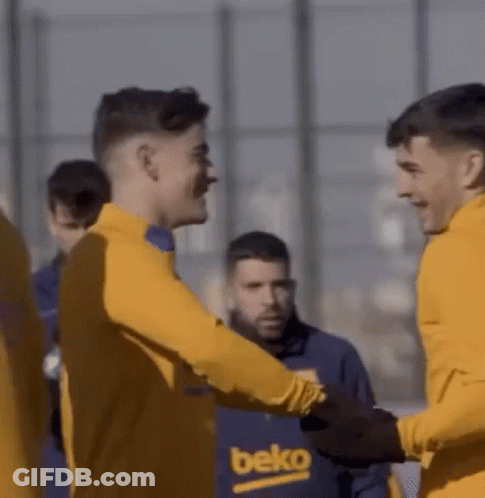 A Group Of Soccer Players Are Shaking Hands While Wearing Yellow Jerseys . GIF