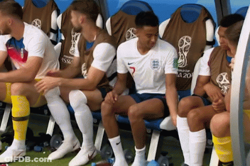 A Group Of Soccer Players Are Sitting In A Locker Room And One Of Them Has The Number 5 On His Jersey GIF