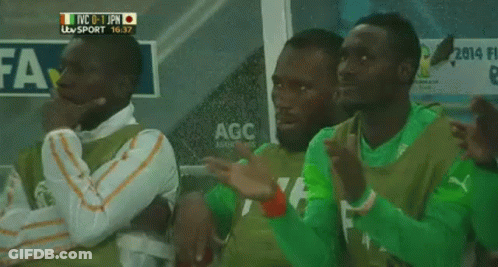A Group Of Soccer Players Are Sitting In A Locker Room With A Sign That Says Agc On It GIF