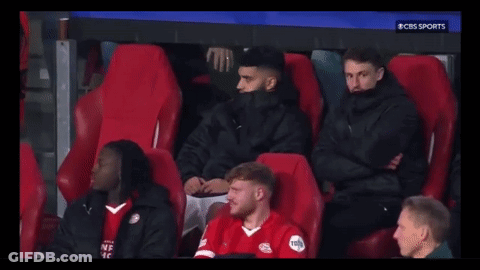 A Group Of Soccer Players Are Sitting In A Stadium Watching A Game On Cbs Sports . GIF