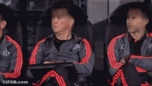 A Group Of Soccer Players Are Sitting In The Dugout Watching A Game . GIF