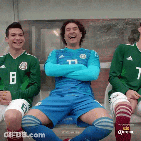 A Group Of Soccer Players Are Sitting On A Bench With Their Arms Crossed And Laughing . GIF