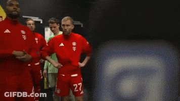 A Group Of Soccer Players Are Standing In A Room With A Yellow Wall That Says Vodafone GIF