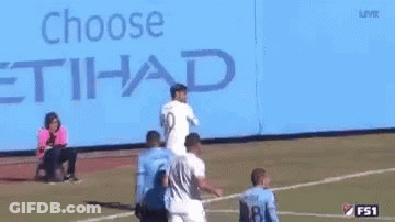 A Group Of Soccer Players Are Standing In Front Of A Blue Background . GIF