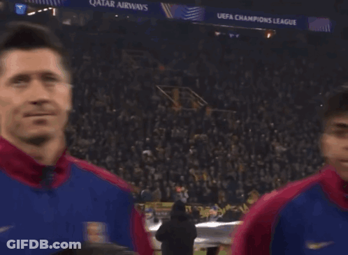 A Group Of Soccer Players Are Standing In Front Of A Crowd With A Qatar Airways Banner In The Background GIF