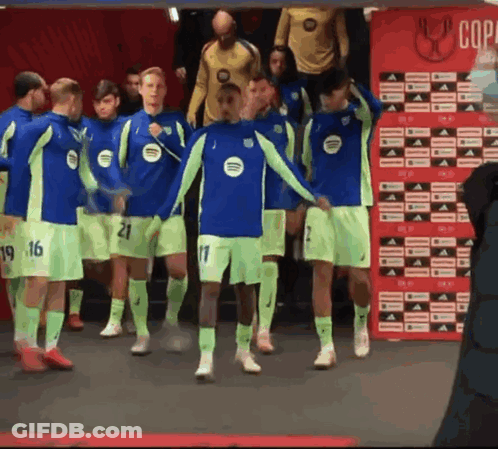 A Group Of Soccer Players Are Standing In Front Of A Red Wall That Says Copa GIF