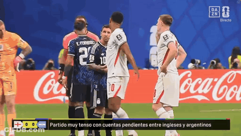 A Group Of Soccer Players Are Standing On A Field In Front Of A Coca Cola Sign GIF