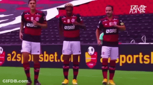 A Group Of Soccer Players Are Standing On A Field In Front Of A Sports Advertisement . GIF