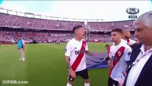 A Group Of Soccer Players Are Standing On A Field With A Fox Sports Logo In The Background GIF