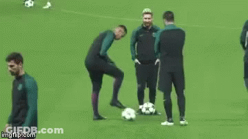 A Group Of Soccer Players Are Standing On A Field With Balls . GIF