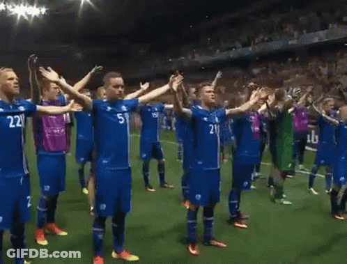 A Group Of Soccer Players Are Standing On A Field With Their Arms Outstretched And One Has The Number 21 On His Shirt GIF