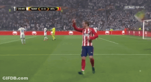 A Group Of Soccer Players Are Standing On A Field . GIF