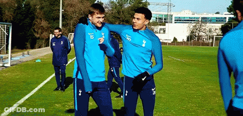 A Group Of Soccer Players Are Standing On A Soccer Field . GIF