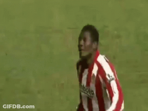 A Group Of Soccer Players Are Standing On Top Of A Soccer Field . GIF