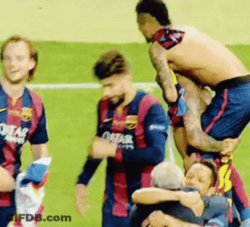 A Group Of Soccer Players Are Standing On Top Of Each Other On A Field . GIF