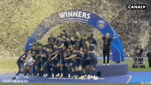 A Group Of Soccer Players Are Standing Under A Banner That Says " Winners " GIF