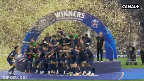 A Group Of Soccer Players Are Standing Under A Banner That Says " Winners " GIF