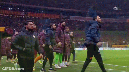 A Group Of Soccer Players Are Walking On A Field With A Banner That Says ' Istanbul ' On It GIF
