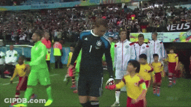 A Group Of Soccer Players Are Walking On A Field With A Sign That Says Neus GIF