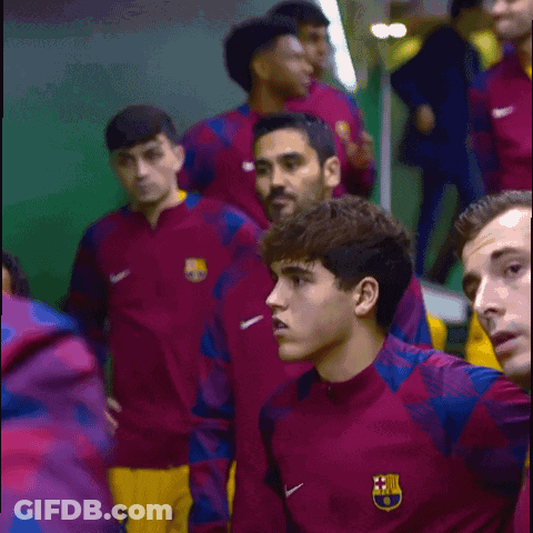 A Group Of Soccer Players Are Wearing Nike Jackets With The Fcb Logo On Them GIF